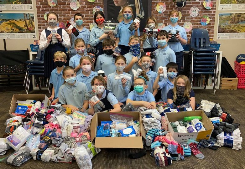 students posed with sock donations